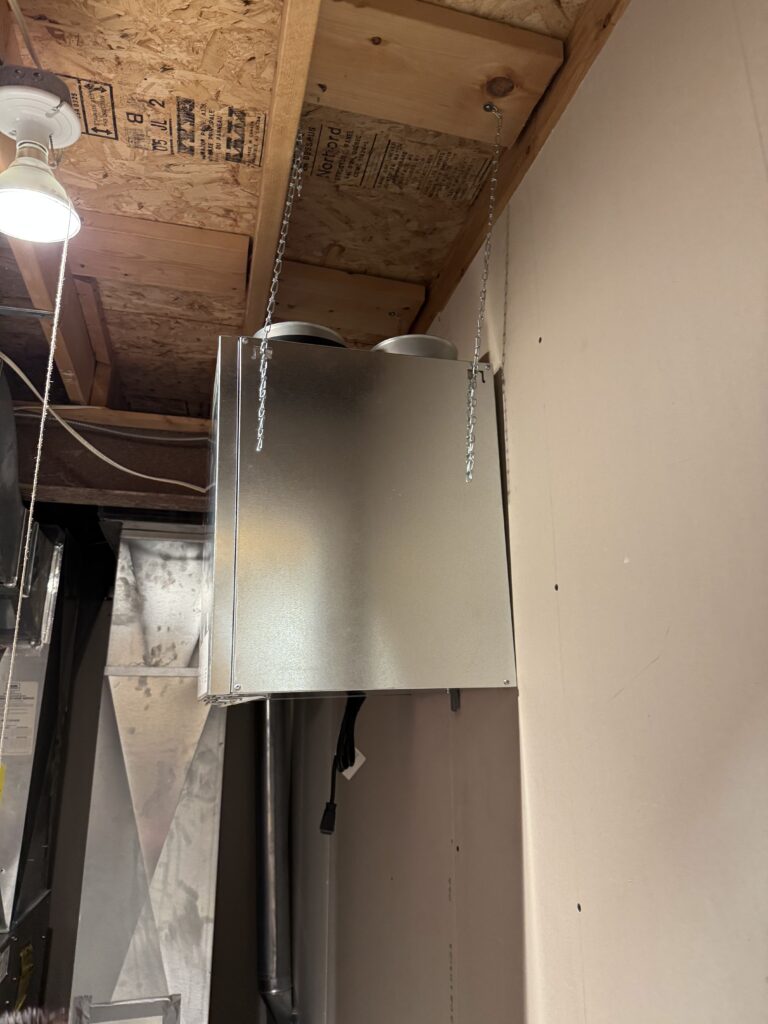 Ductworkers installing and sealing overhead pipework